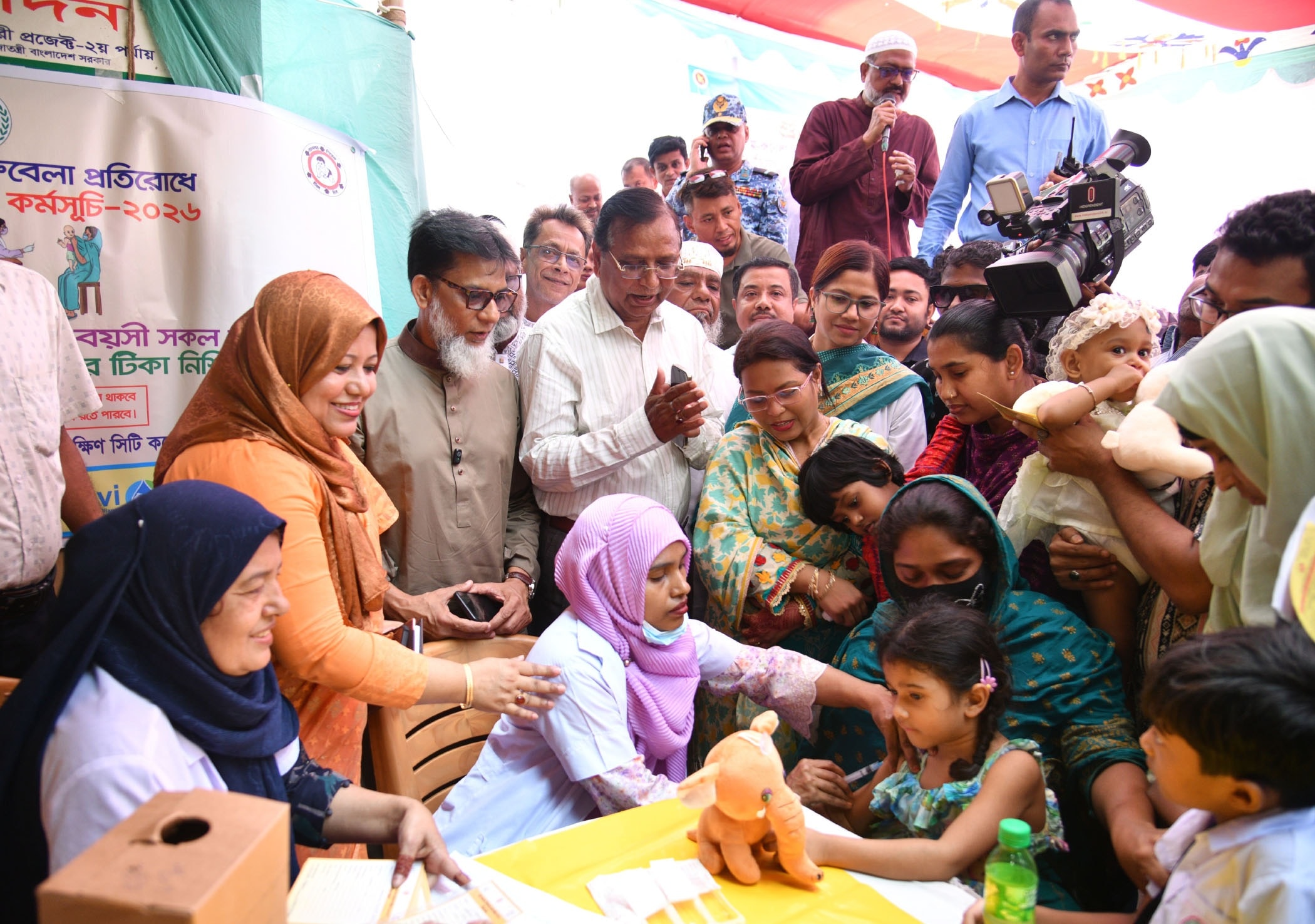 A Bangladeshi child receives a measles-rubella vaccine at a Dhaka vaccination booth during the 2026 nationwide MR campaign.