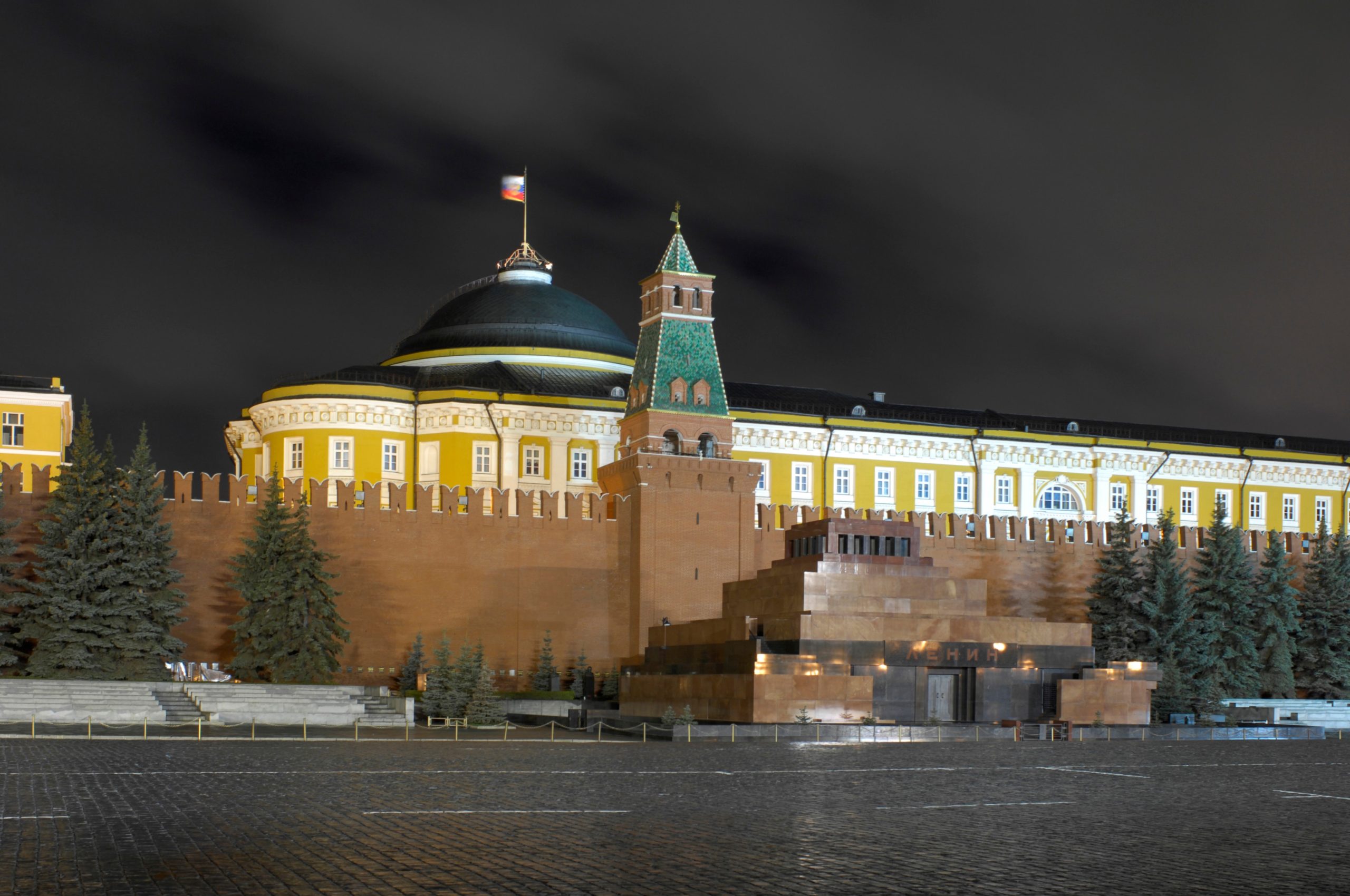 The Moscow Kremlin Senate building and Senatskaya Tower lit at night in Red Square.
