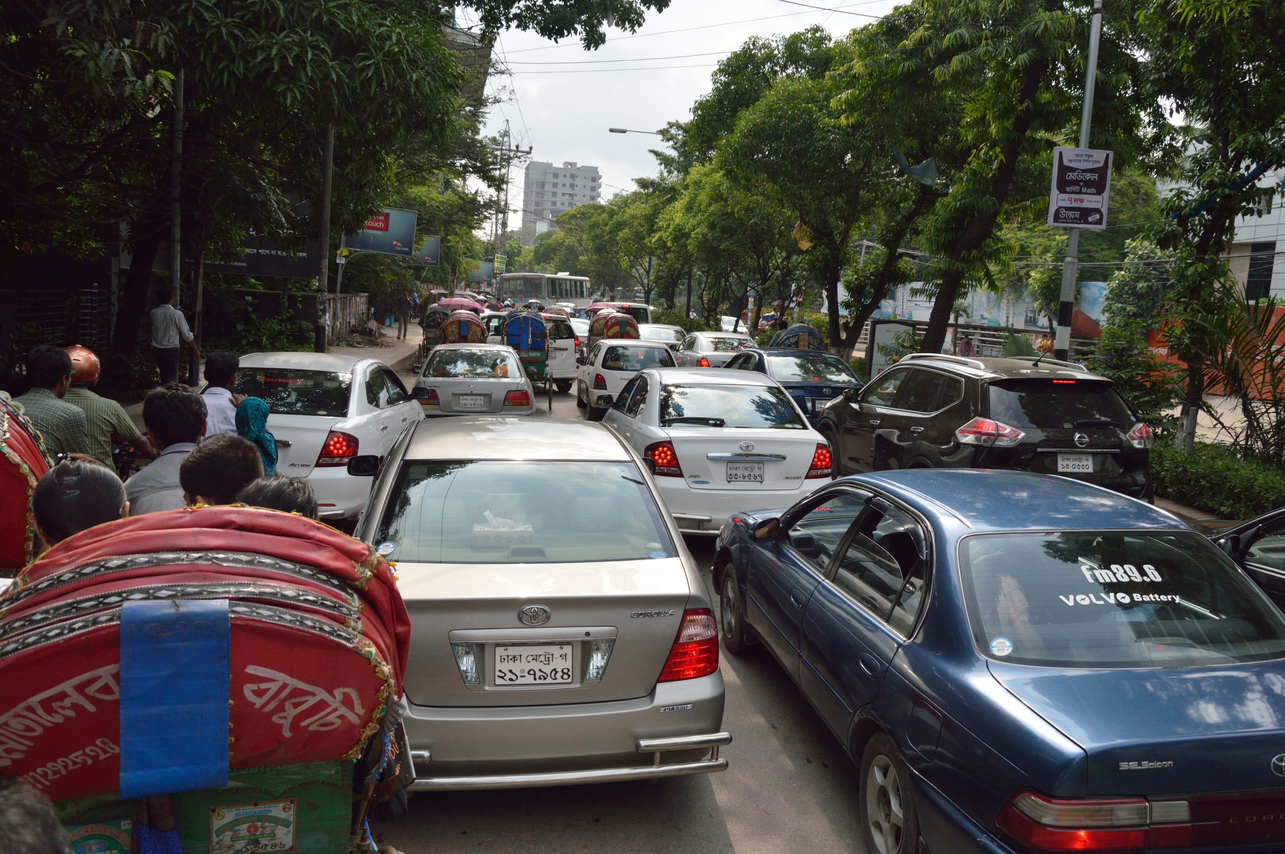 Cars, rickshaws and auto-rickshaws in daily traffic on Road 2, Dhanmondi, Dhaka.