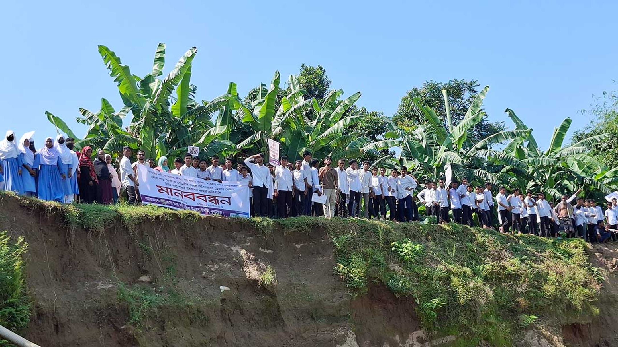 Students rally to save embankment on Dhopajan river