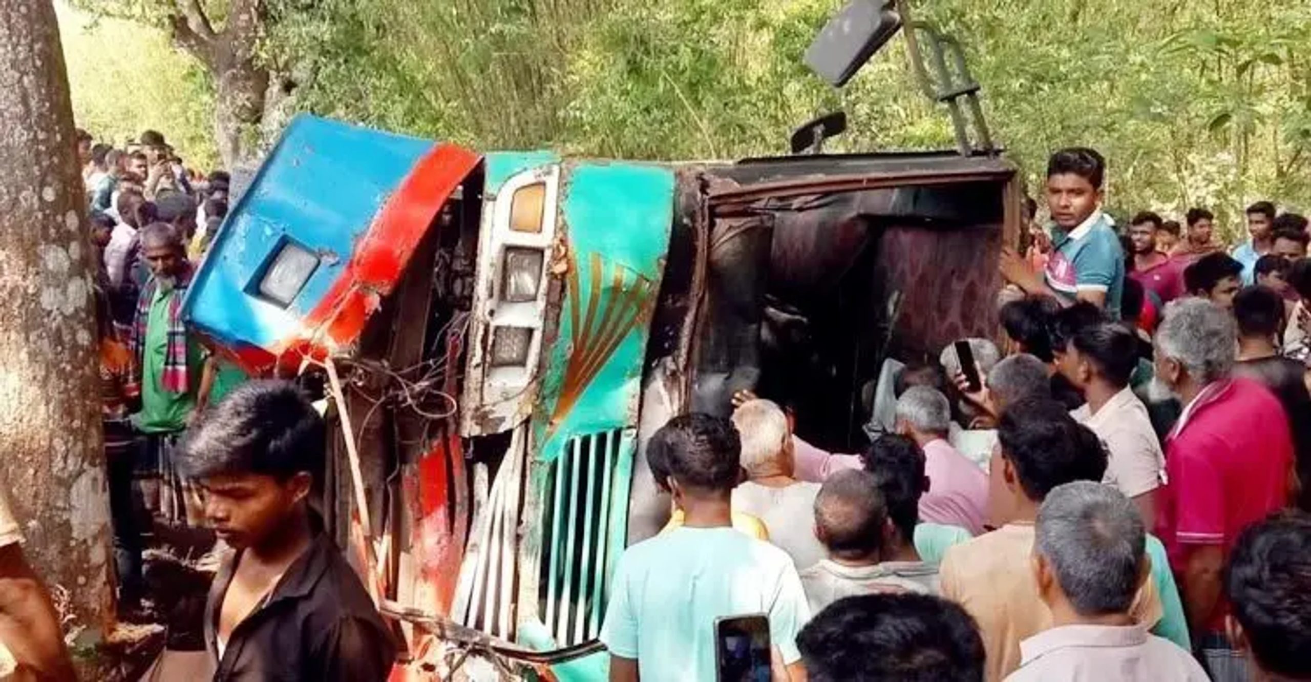 Passenger bus overturns after hitting tree in Debiganj