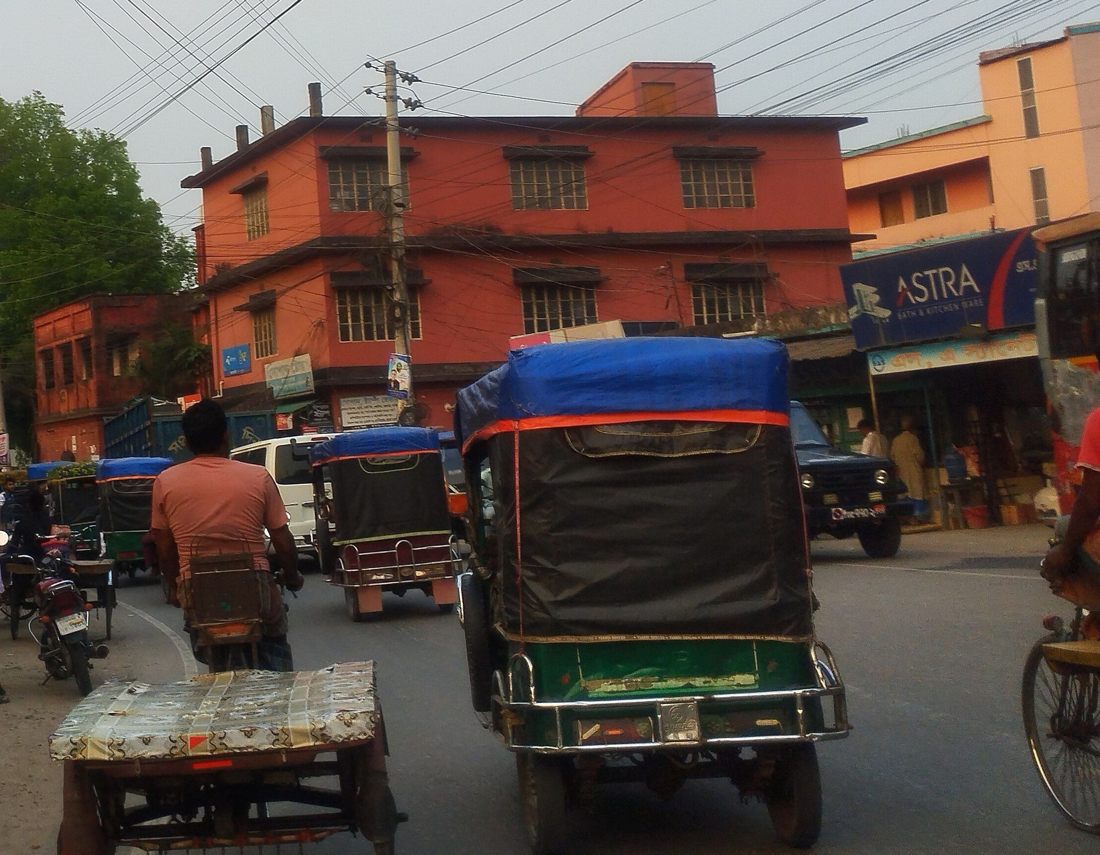 Battery-run vans and rickshaws on a road in Chuadanga